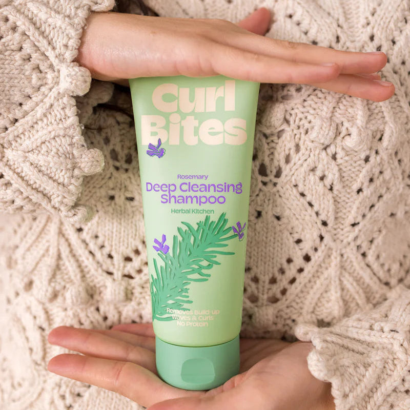 Handen houden Curl Bites Deep Cleansing Shampoo 200ml vast, benadrukt CG-vriendelijke formule voor diepe reiniging van krullen zonder proteïne.