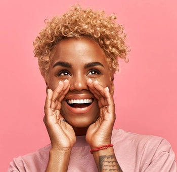 Girly Girl with pink background. She had her hands around her mounth as if she wants to do a happy scream.